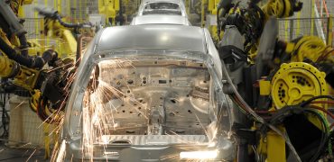 Image of steel body structures being welded in an automotive plant assembly line