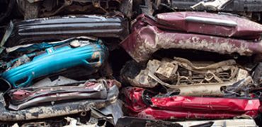 Flattened vehicles on top of each other for recycling